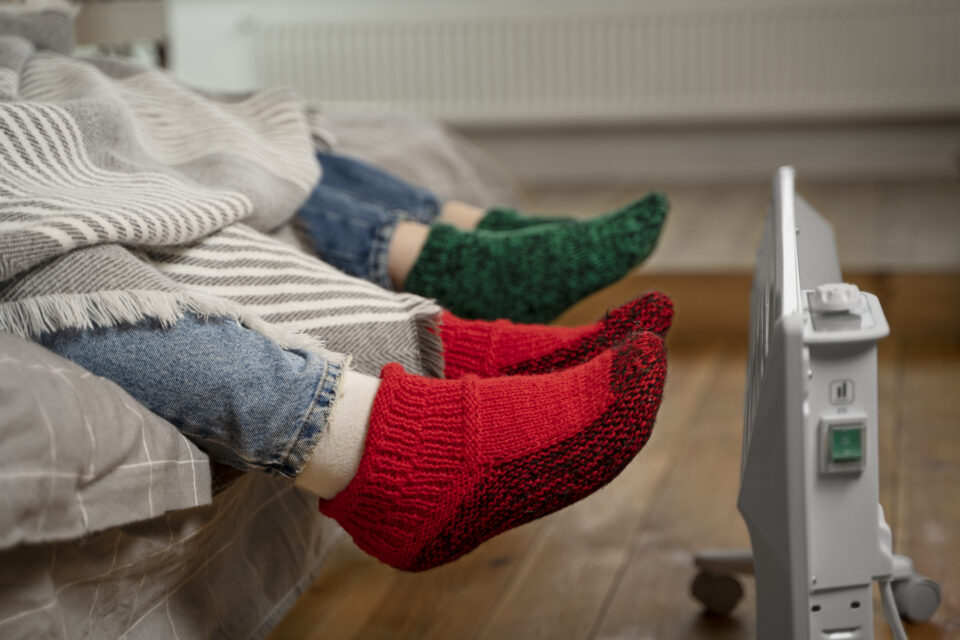 close-up-feet-getting-warm-near-heater